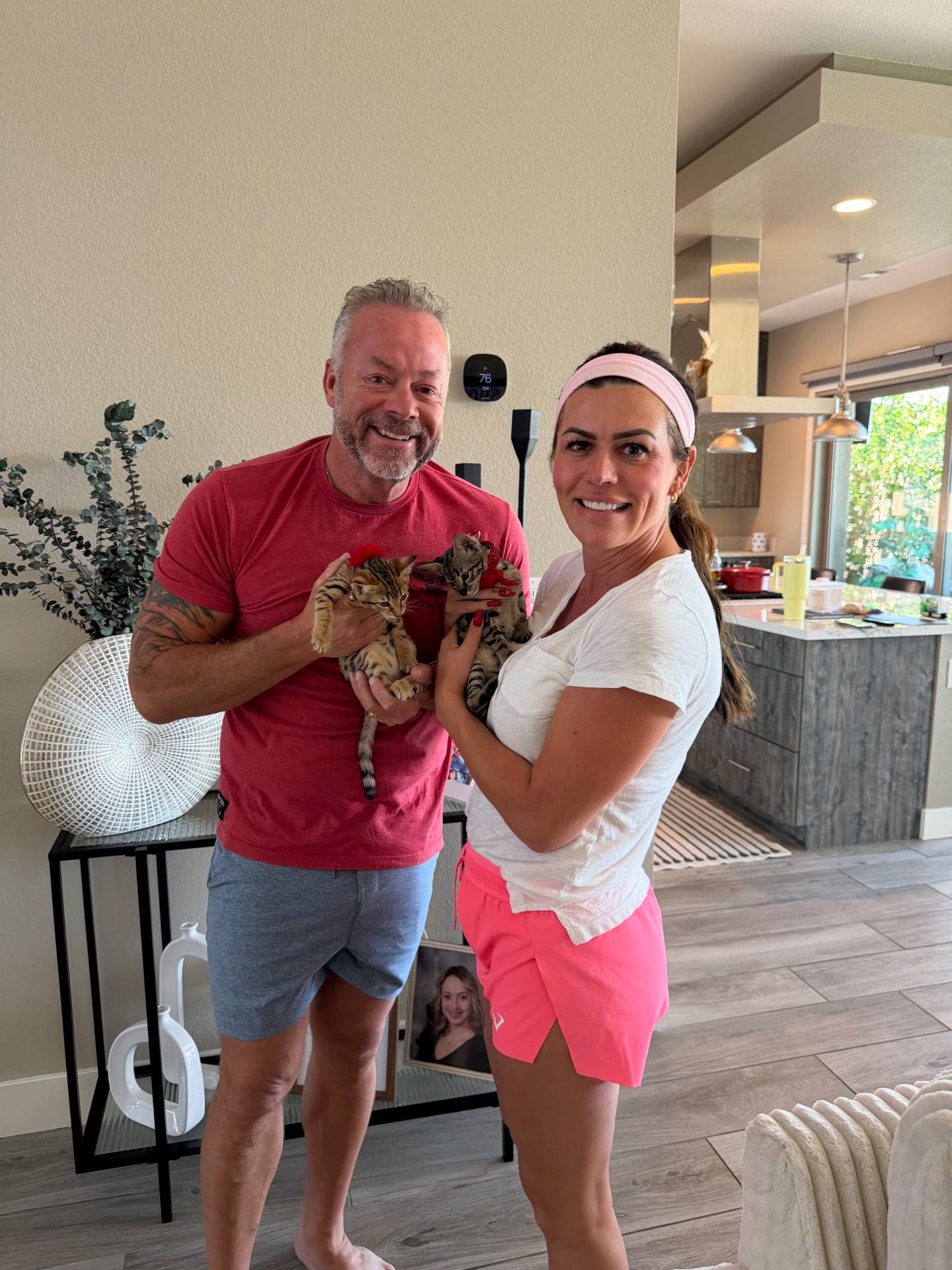 Clover and Cloud, SBT Savannah kittens from LVHYBRIDS, held by their new family on go-home day